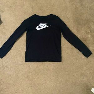 Long sleeve all black shirt , with the word “Nike” on the front in white